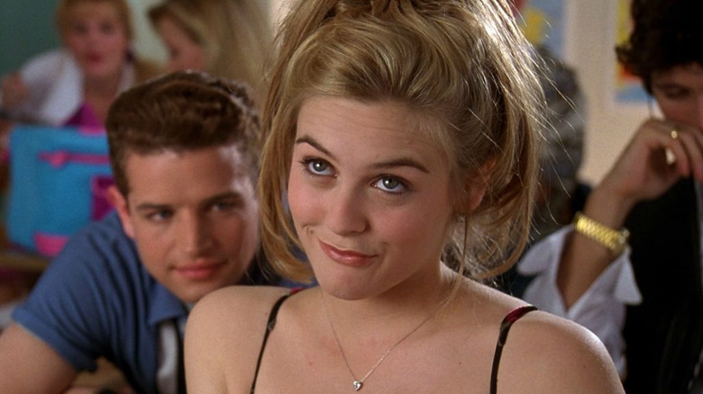 Alicia Silverstone as Cher smirking in class in Clueless